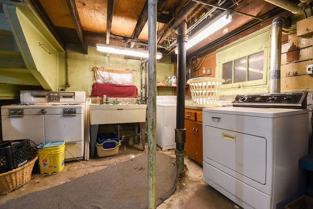 clothes washing area with sink and washer and dryer