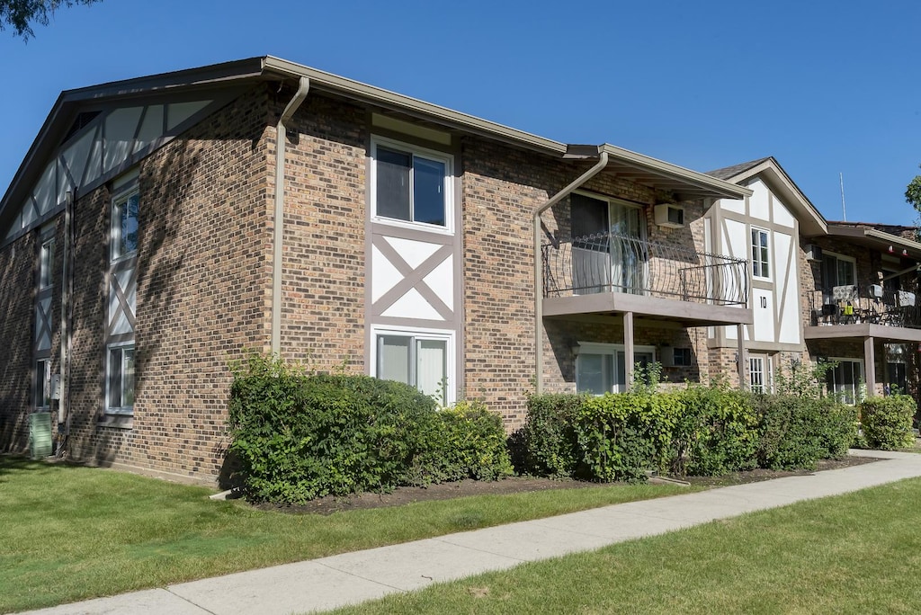 view of property exterior with a balcony and a yard