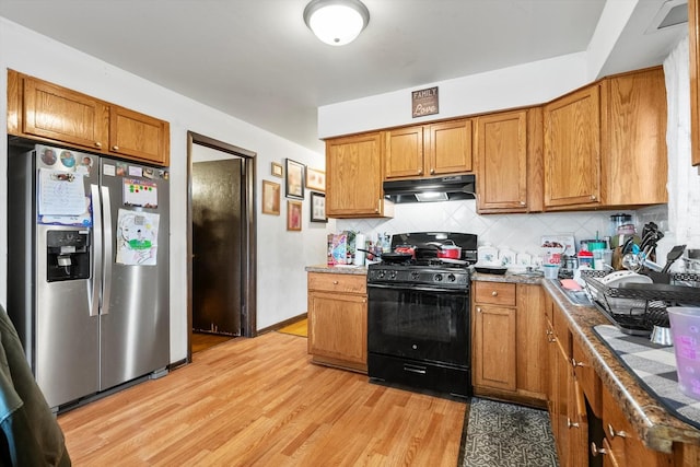 kitchen featuring tasteful backsplash, black range with gas cooktop, light wood-type flooring, and stainless steel fridge with ice dispenser