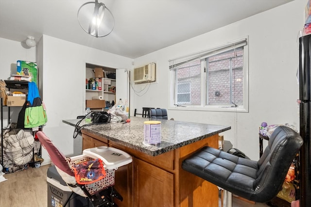 office space featuring light wood-type flooring and a wall unit AC