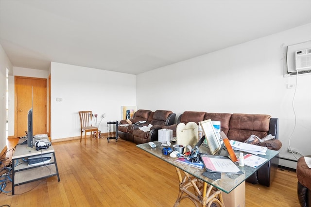 living room featuring light hardwood / wood-style floors and a baseboard heating unit