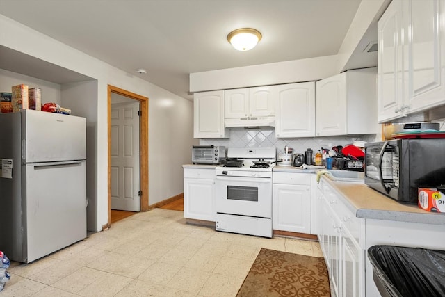 kitchen featuring white appliances, decorative backsplash, and white cabinets