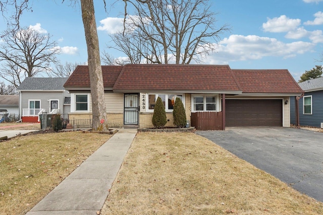 ranch-style home with a garage and a front yard