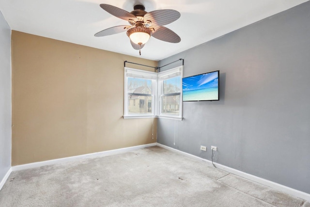 unfurnished room with light colored carpet and ceiling fan