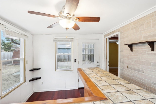 interior space with ceiling fan