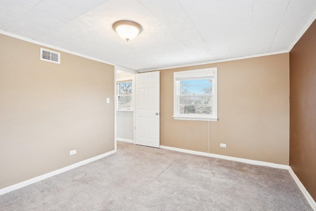 empty room with light colored carpet and ornamental molding