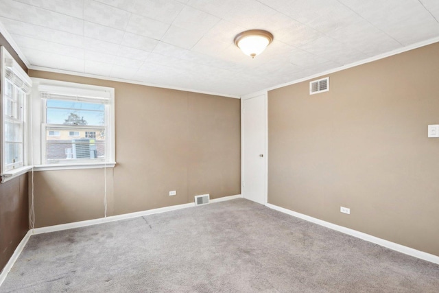 unfurnished room featuring ornamental molding and carpet