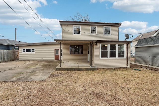 back of property featuring a patio area and a lawn