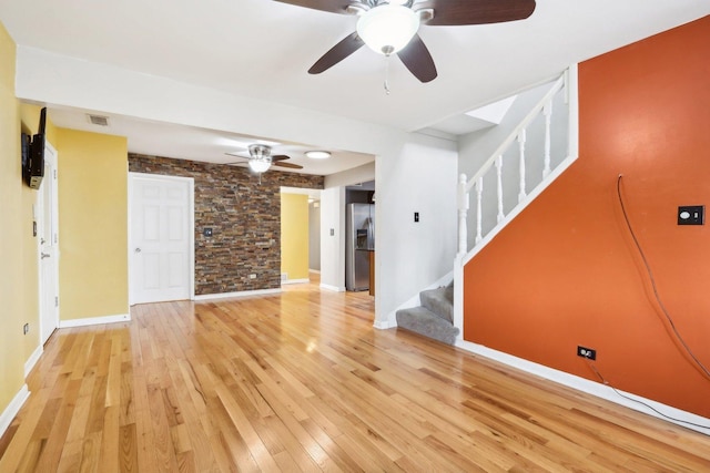 unfurnished living room with light hardwood / wood-style flooring and ceiling fan