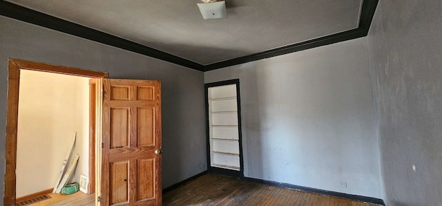 interior space with crown molding, dark hardwood / wood-style flooring, and vaulted ceiling