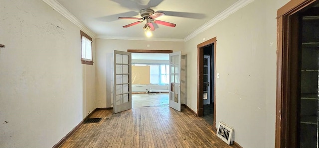 hallway with ornamental molding, dark hardwood / wood-style floors, and french doors