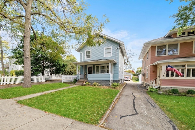 view of front of property with a front yard and covered porch