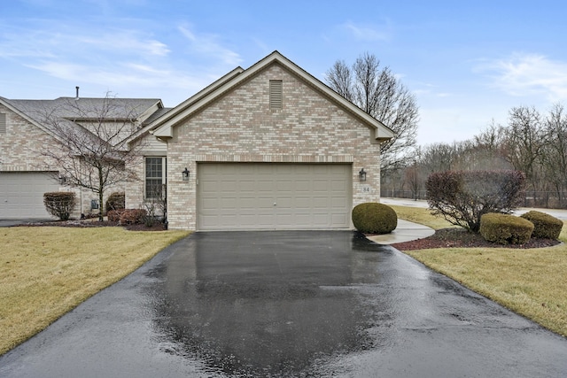 view of front of house with a garage and a front lawn