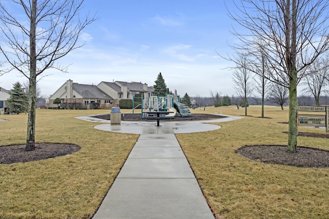 view of property's community featuring a playground and a lawn