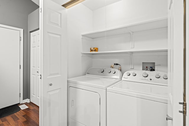 washroom featuring dark hardwood / wood-style flooring and independent washer and dryer