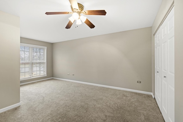 unfurnished bedroom with ceiling fan, a closet, and carpet