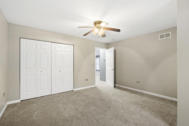 unfurnished bedroom with carpet floors, a closet, and ceiling fan