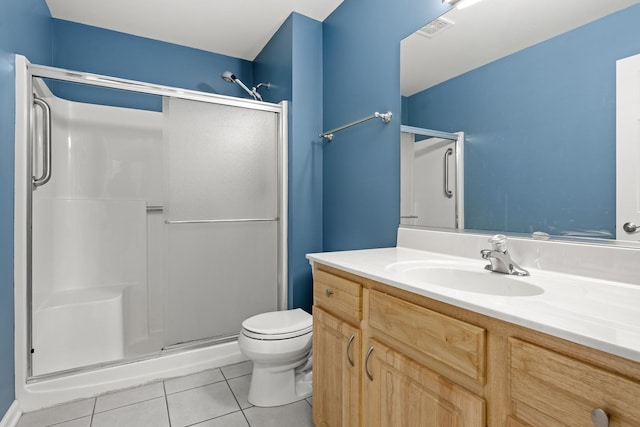 bathroom with an enclosed shower, vanity, tile patterned floors, and toilet