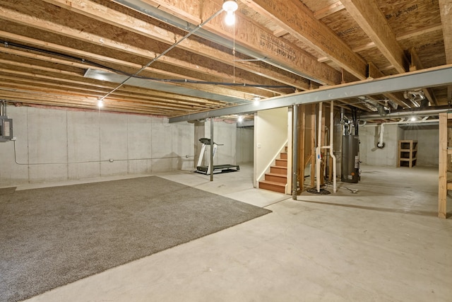 basement featuring gas water heater and electric panel