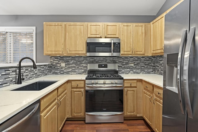 kitchen with stainless steel appliances, dark hardwood / wood-style floors, light brown cabinetry, and sink