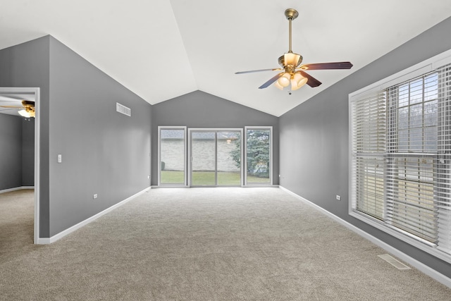 unfurnished living room with vaulted ceiling, ceiling fan, and carpet