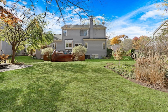 back of house with a wooden deck and a yard