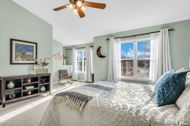 carpeted bedroom featuring ceiling fan and lofted ceiling