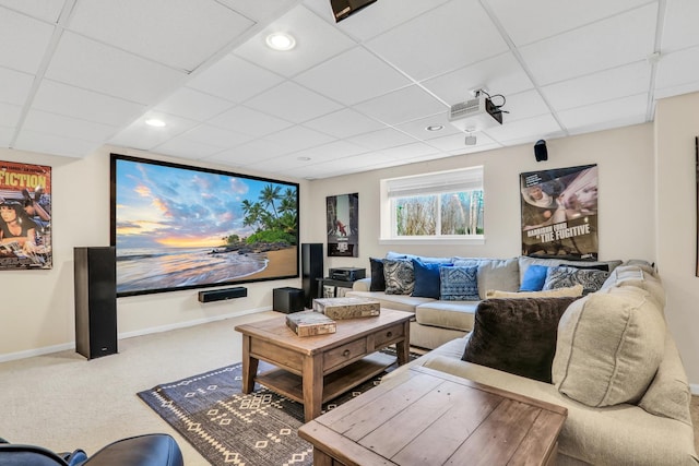 carpeted home theater featuring a drop ceiling