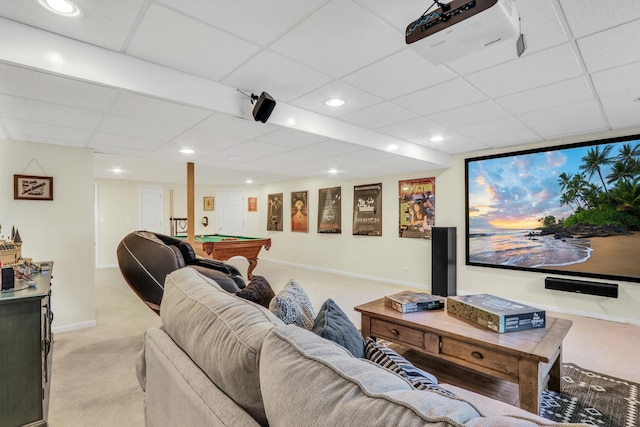 carpeted cinema room with billiards and a drop ceiling