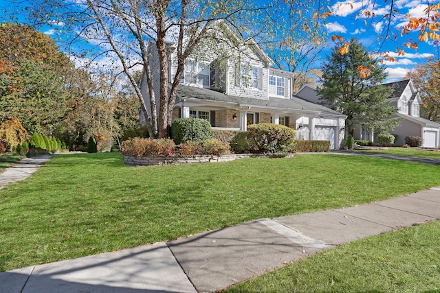 view of front property featuring a garage and a front yard