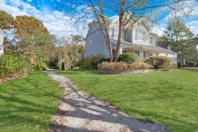 view of side of property with a lawn