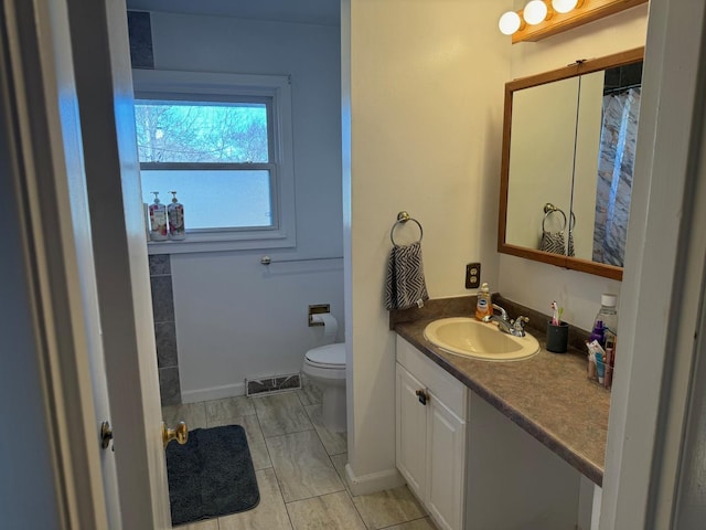 bathroom with vanity and toilet