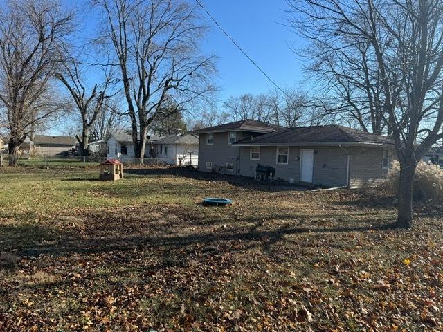 rear view of property with a lawn