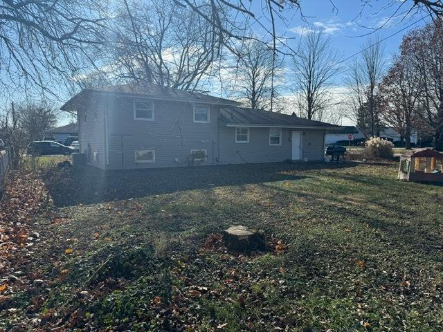 back of house with a lawn