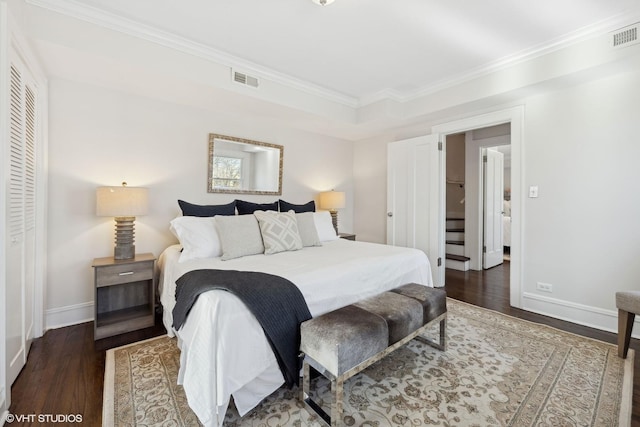 bedroom with dark wood-type flooring and ornamental molding