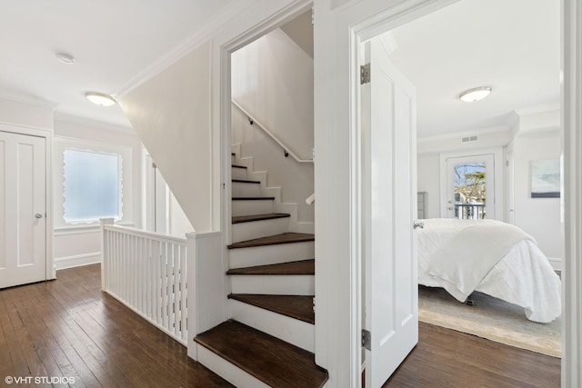 stairway with hardwood / wood-style flooring and ornamental molding