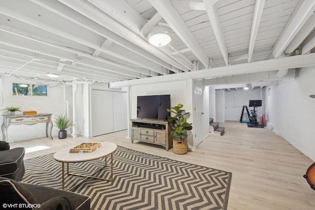 living room featuring beam ceiling and light wood-type flooring