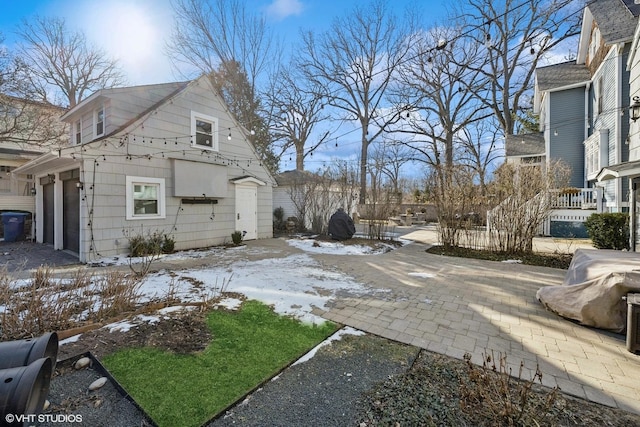 view of snowy exterior with a garage