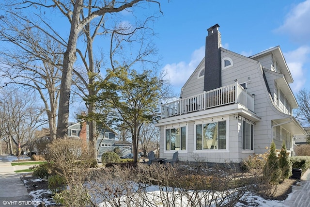 snow covered property with a balcony