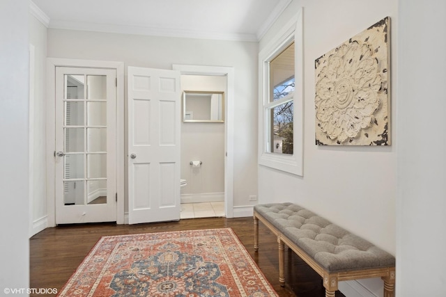 hall featuring dark wood-type flooring and ornamental molding