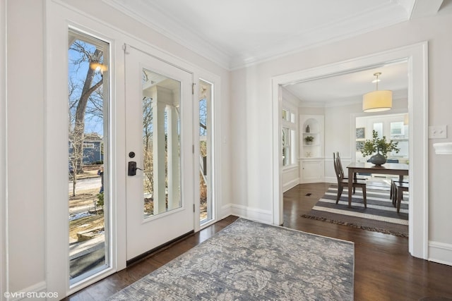 foyer entrance with crown molding and dark hardwood / wood-style flooring