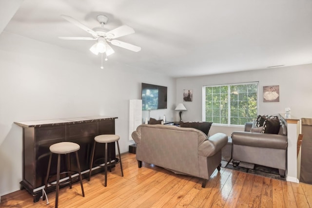 living room featuring ceiling fan and light wood-type flooring