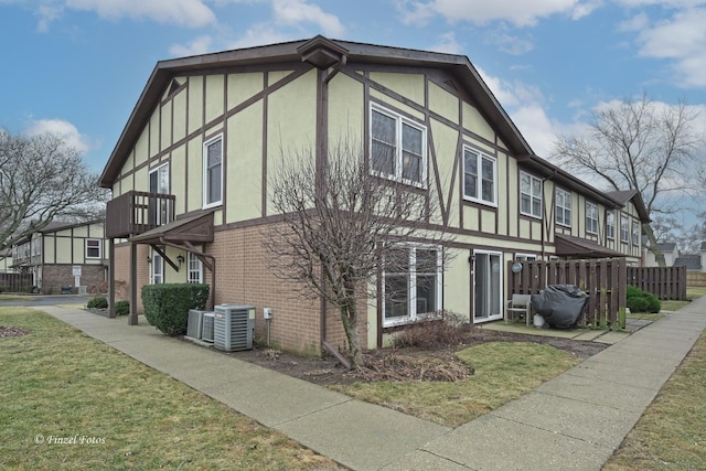 view of property exterior featuring cooling unit and a yard