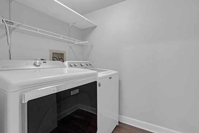 washroom featuring dark wood-type flooring and washing machine and clothes dryer