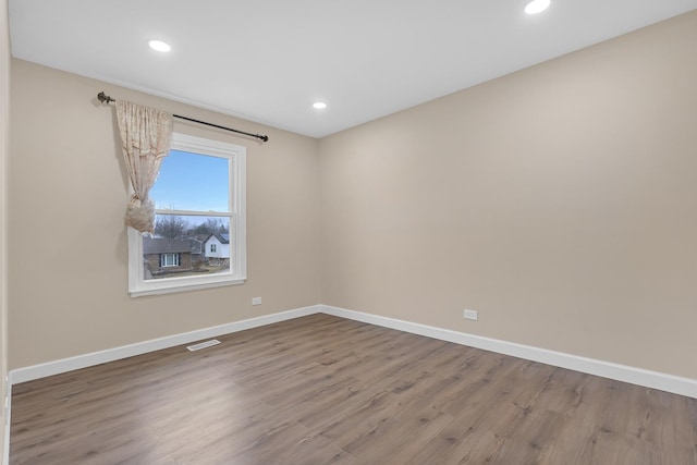 spare room with wood-type flooring