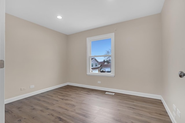 empty room featuring hardwood / wood-style flooring