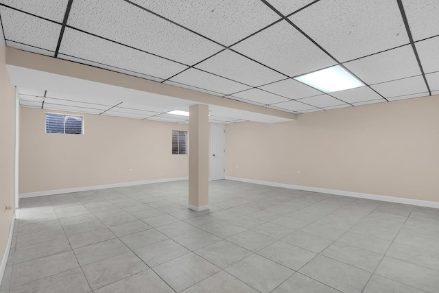 basement with a paneled ceiling