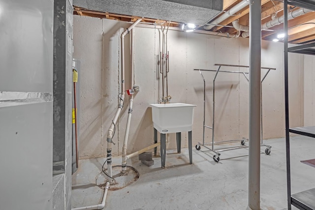 basement with sink and heating unit