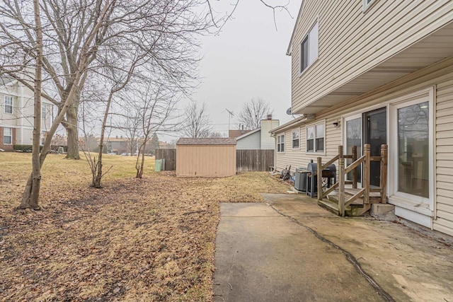 view of yard featuring a patio area and a storage unit