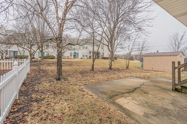 view of yard featuring an outdoor structure and a patio area